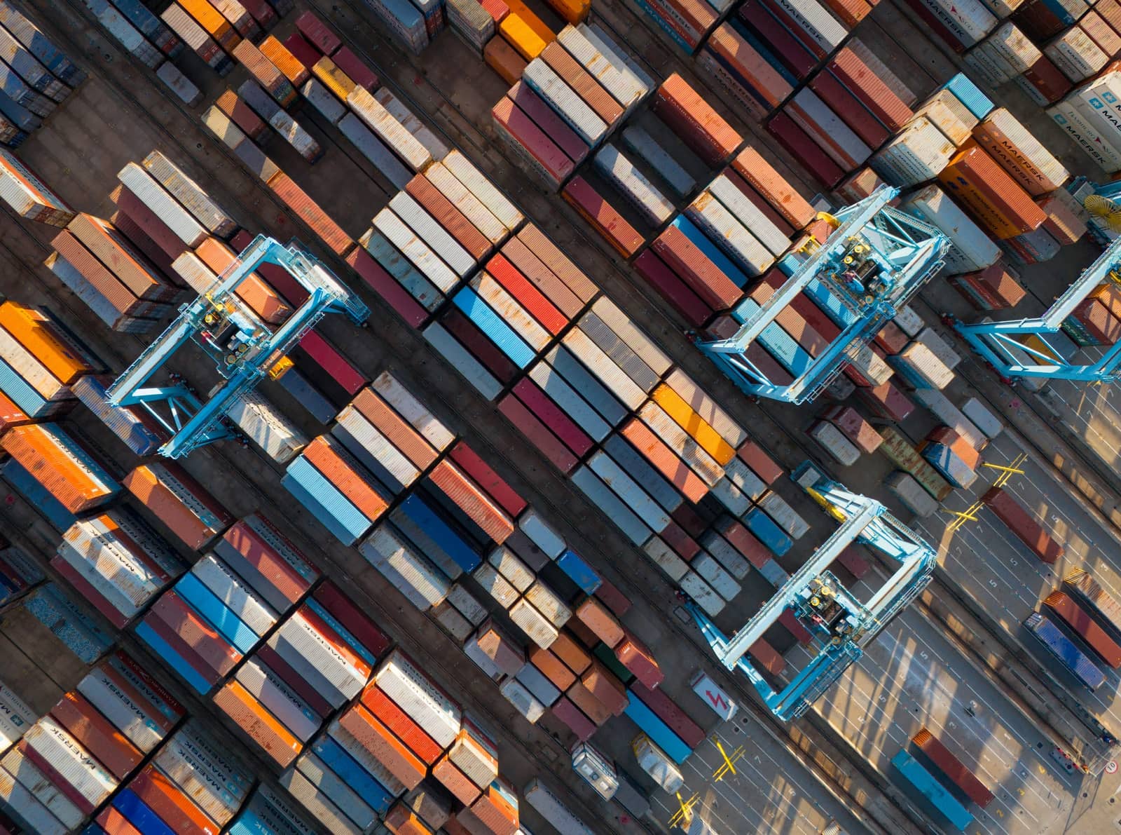 Aerial view of a container yard with cranes and stacked containers